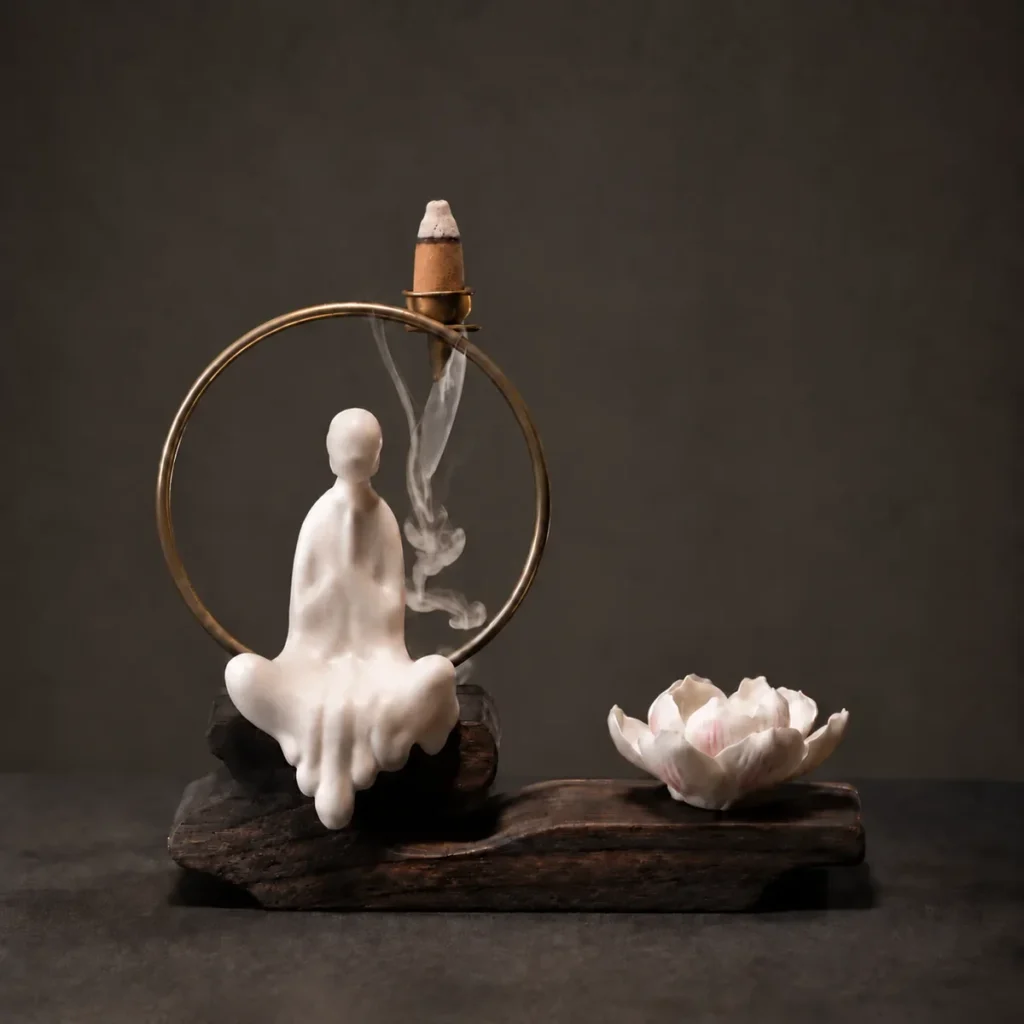 White ceramic backflow incense burner with smoke flowing beneath a burning cone