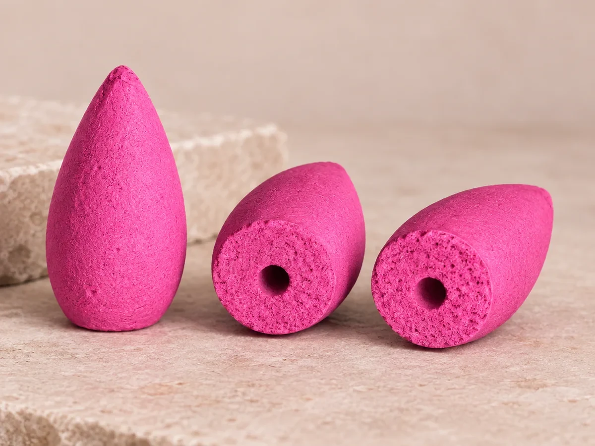 Three rose backflow incense cones, two showing hollow base openings