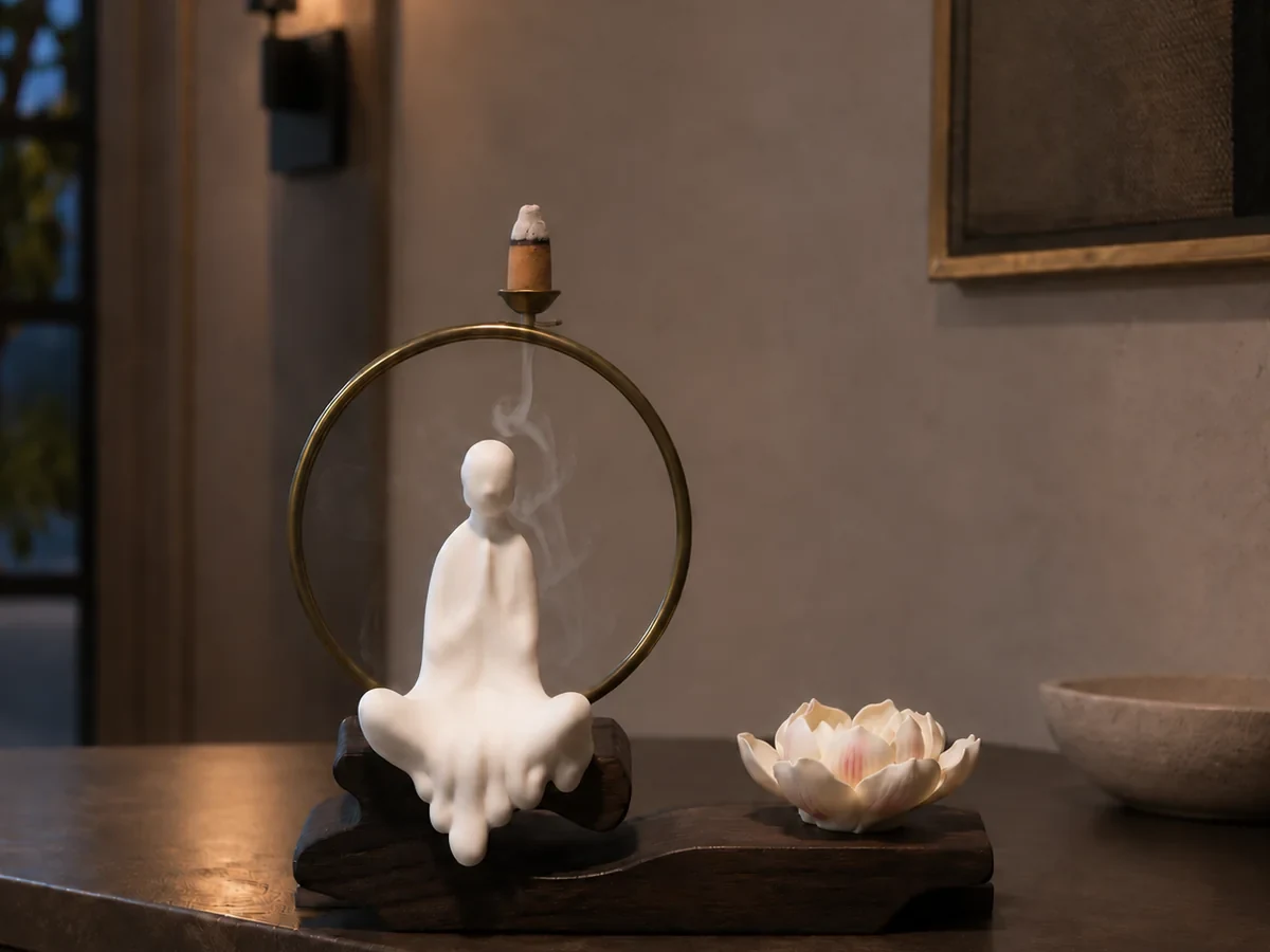 White backflow incense burner arranged on a clear, stable tabletop